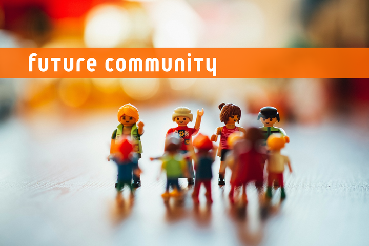 Small plastic people hanging out on top of a table. Above them are the words future community which is also the name of this newsletter.