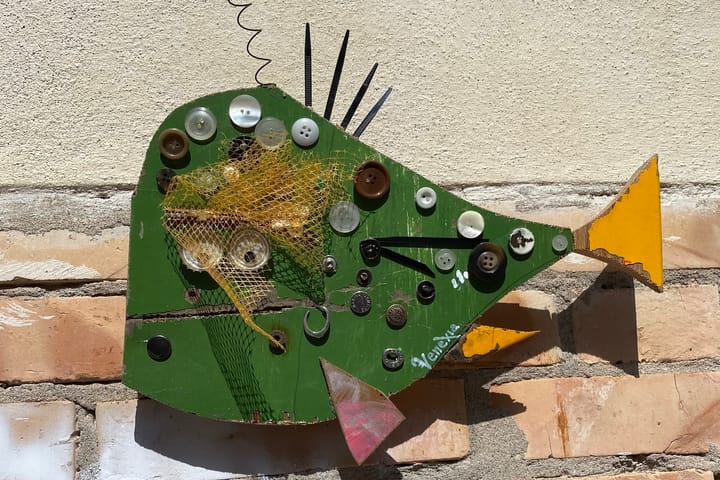 A wooden fish on a wall in Venice, Italy.